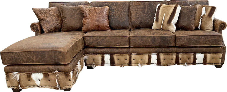 Front view of the Sanaa Springbok Sectional Sofa showcasing Cora Pecan oil-finished leather with Springbok hide accents on the bottom rail and Gator Hornback Rustic Cognac leather on the rolled arms.