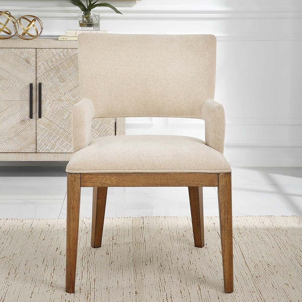 Dining chair with a modern open-back design, upholstered in sand fabric, and crafted with solid wood legs.