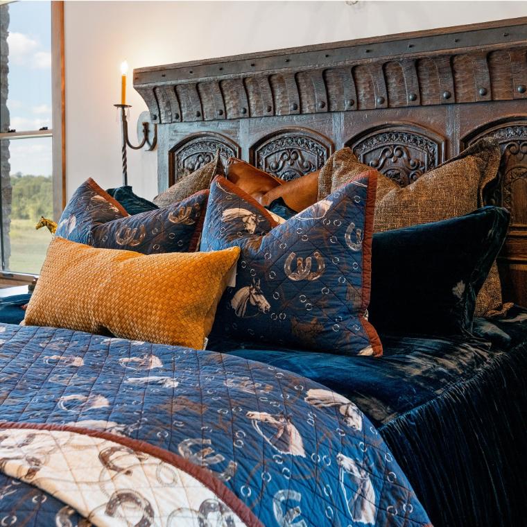Detailed view of the matching pillow shams featuring coordinated equine-themed illustrations on a navy blue background.