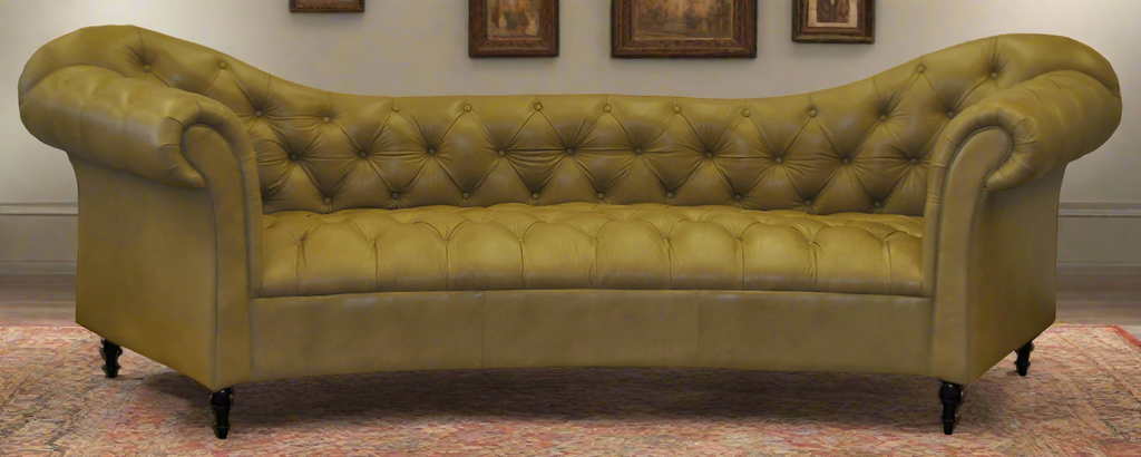 Brown leather sofa with scalloped tufted backrest and tufted seat on a white background in living room setting