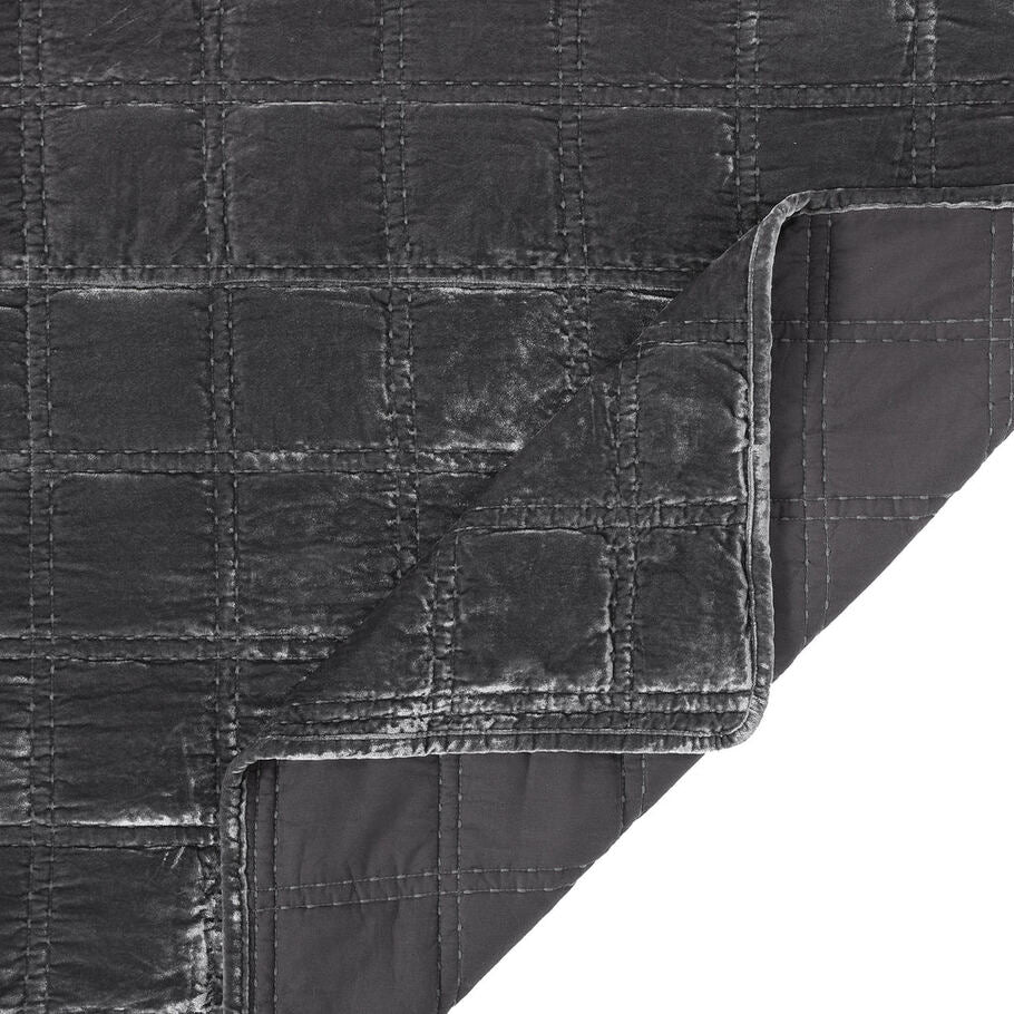 Close-up of the quilt's corner, displaying the precise stitching and plush velvet texture in a soothing slate gray shade.