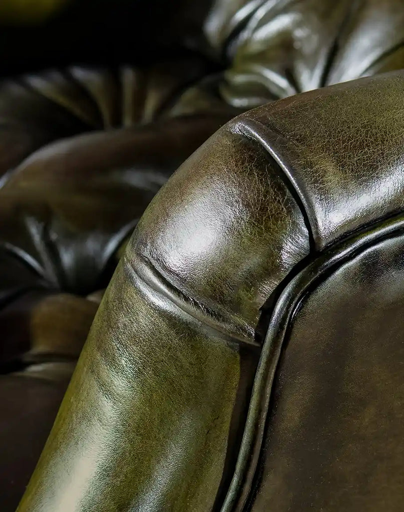 A close-up of the recliner’s hand-stitched leather armrests, showcasing expert craftsmanship and durability.