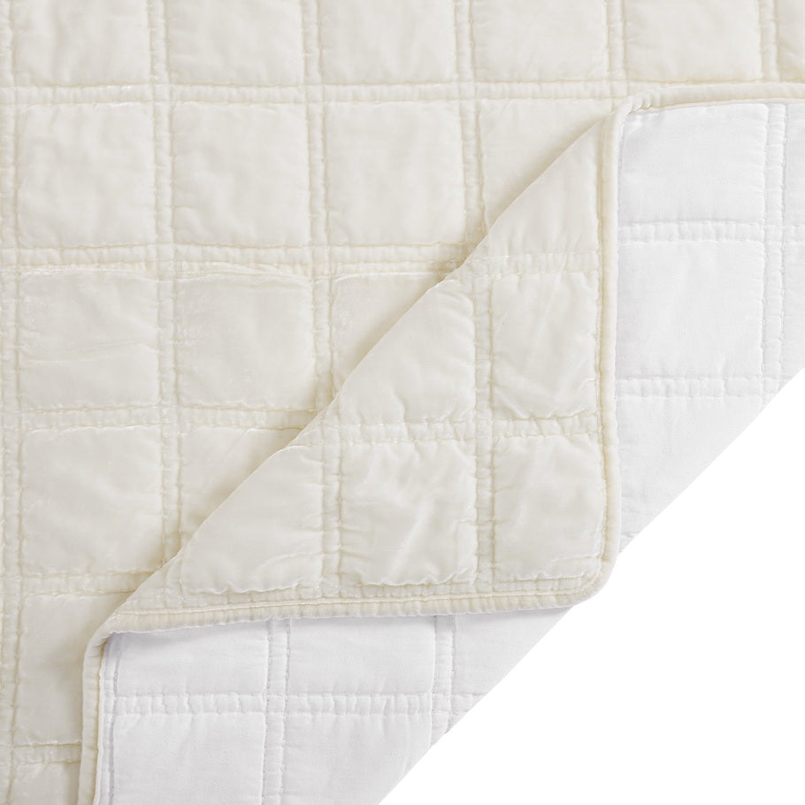 Close-up of the quilt's corner, displaying the precise stitching and plush velvet texture in a calming stone shade.