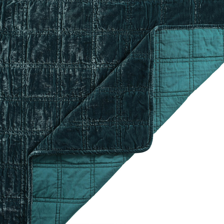 Close-up of the quilt's corner, displaying the precise stitching and plush velvet texture in a soothing storm blue shade.