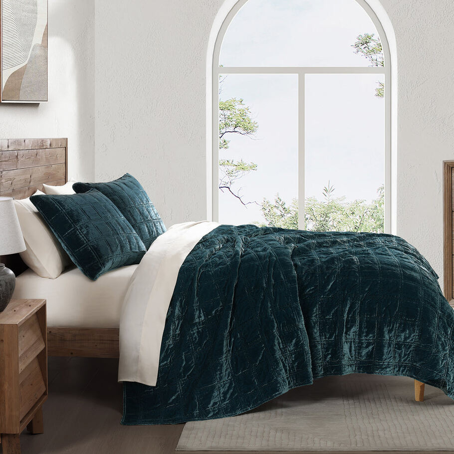 Storm Blue Faux Silk Velvet Quilt Set styled in a contemporary bedroom, complementing neutral tones and minimalist décor.