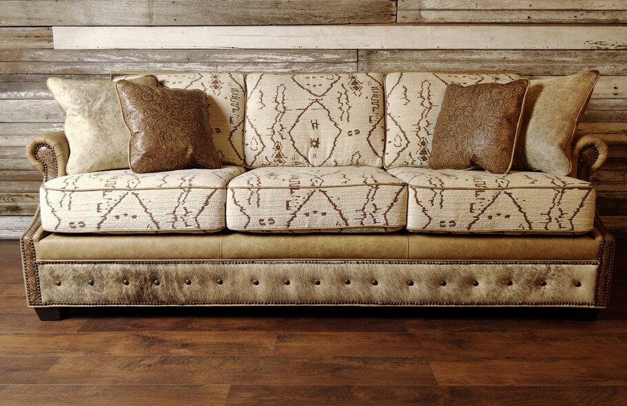 Front view of The Highlands Sofa showcasing its Longhorn Oatmeal leather upholstery and Floral Brown Sugar leather accents.
