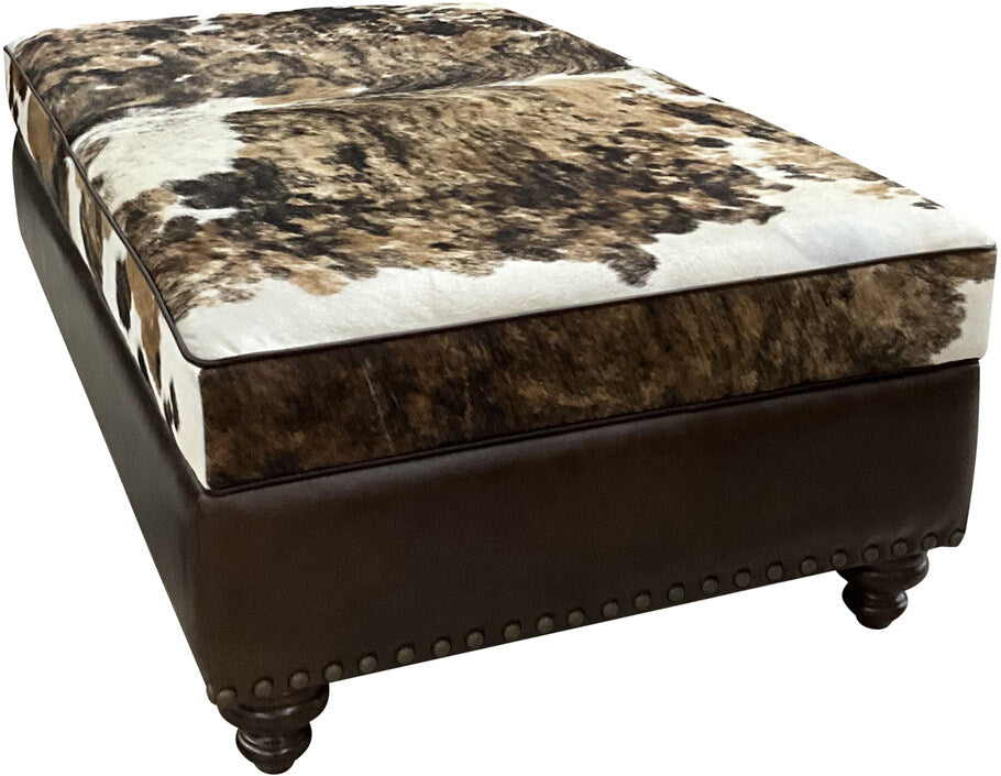 Top view of The Highlands Storage Ottoman showcasing the tri-color brindle cowhide cushion and distressed Kodiak Bear leather base.