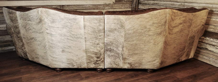 The back of The Ranchman Curved Sectional, featuring exotic brindle cowhide along the outer arms and backrest, adding texture and natural Western charm.