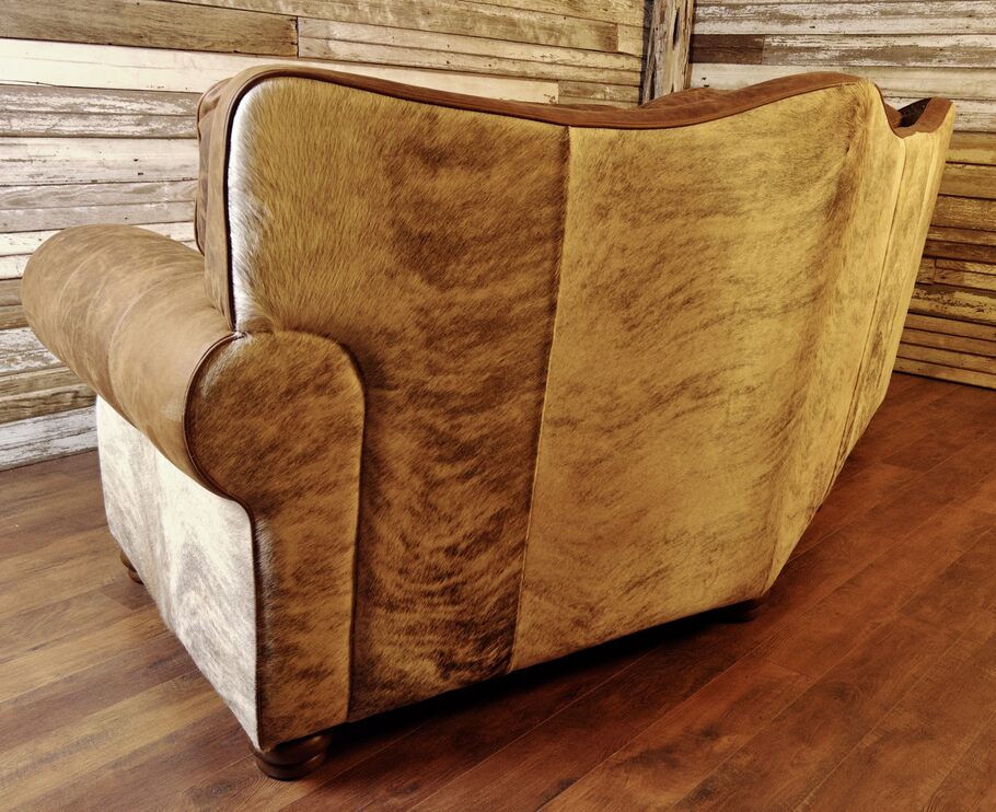 A focused view of the light exotic brindle cowhide featured on the back and sides of the sectional, adding a distinctive rustic character and natural beauty.