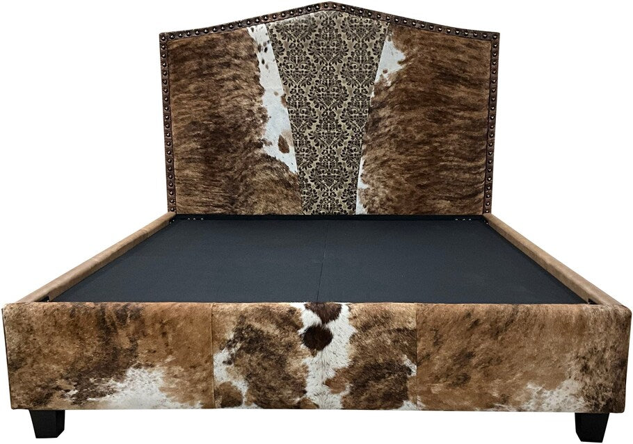 The Venetian Cowhide Bed showcases a grand upholstered headboard with exotic brindle cowhide and a Verona Stone leather "V" insert, framed by Palio Camel leather for a rustic yet elegant Western design.