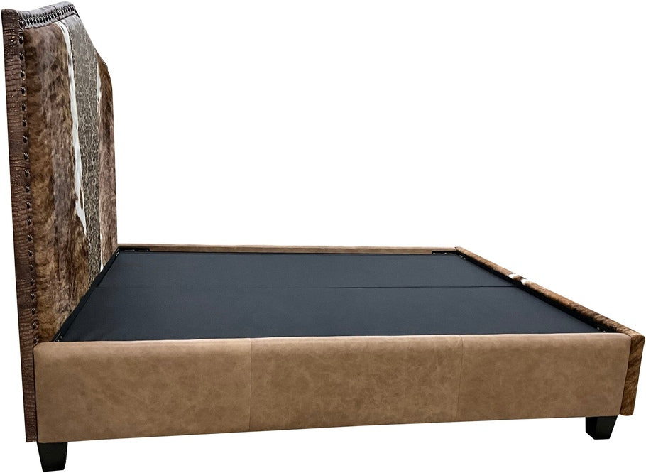 A side view of The Venetian Cowhide Bed, highlighting the rich Palio Camel leather on the rails and footboard, complemented by the luxurious brindle cowhide panel for a striking Western aesthetic.