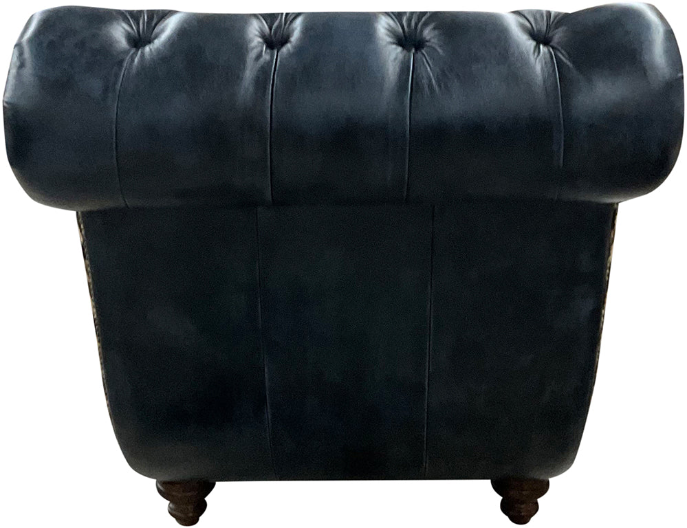 Back view of chaise lounger showing rolled headrest with tufted back and wooden legs