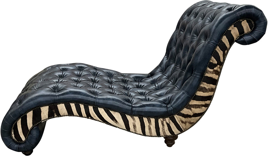 Black tufted chaise lounger with genuine zebra hide on each side of chair plus nailhead trim