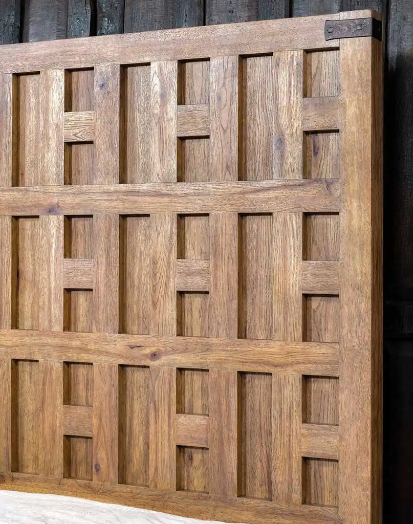 Detailed close-up of the intricately carved headboard on the Tiara Sand Wooden Bed, showcasing its elegant craftsmanship and rustic charm.