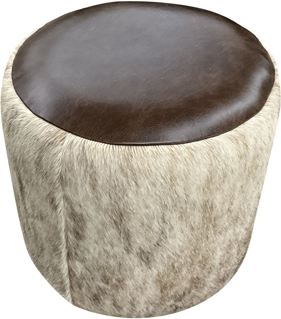 Close-up of the Alaskan Cowhide Round Barrel Ottoman, showcasing its premium light cowhide exterior and durable Kodiak Bear leather top, ideal for game rooms, reading nooks, or stylish footrests.