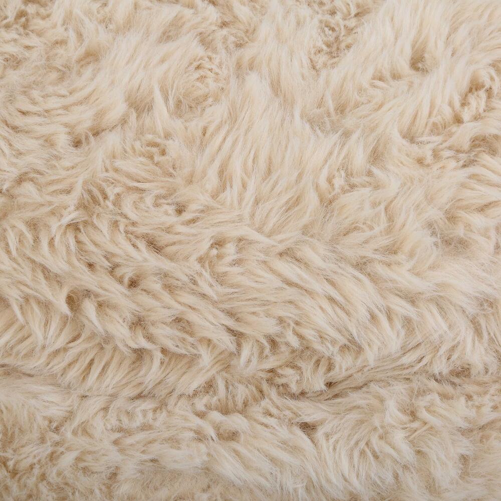 Close-up of the Carmela Swivel Chair’s luxurious faux sheepskin texture.