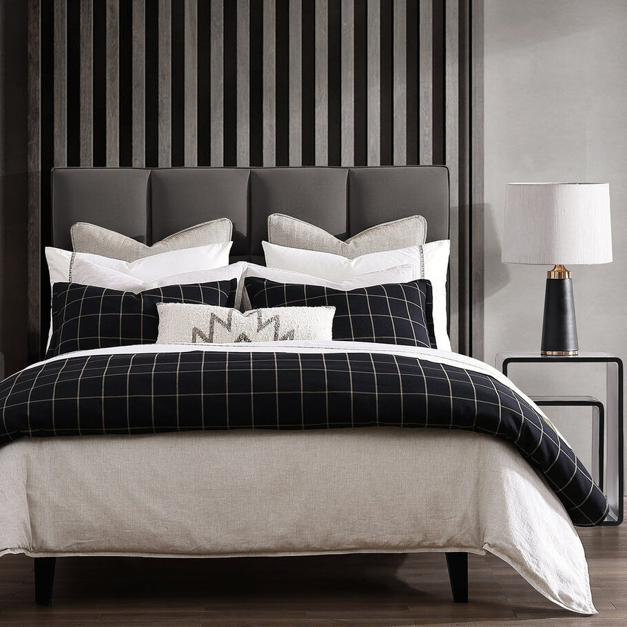 Windowpane Plaid Black Lodge Comforter Set paired with matching pillow shams and faux fur throws, creating a cohesive and inviting lodge-inspired look.