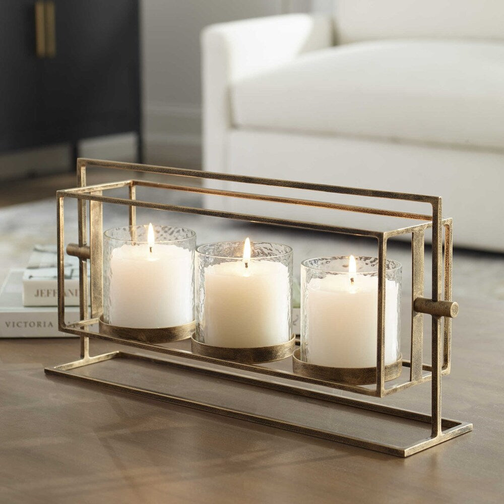 Triple candle lantern with antique gold iron stand, textured glass hurricanes, and three 3"x 3" white pillar candles.