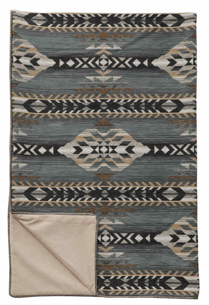 Spearhead Dusk 55x72 Throw by Wooded River featuring a bold southwestern diamond motif in grey-blue, brown, tan, grey-black, and white tones. Crafted from a 91% Polypropylene and 9% Polyester blend with a soft Chamois Suede backing. Adds rugged sophistication and warmth to any space. Coordinates with the full Spearhead Dusk bedding collection.