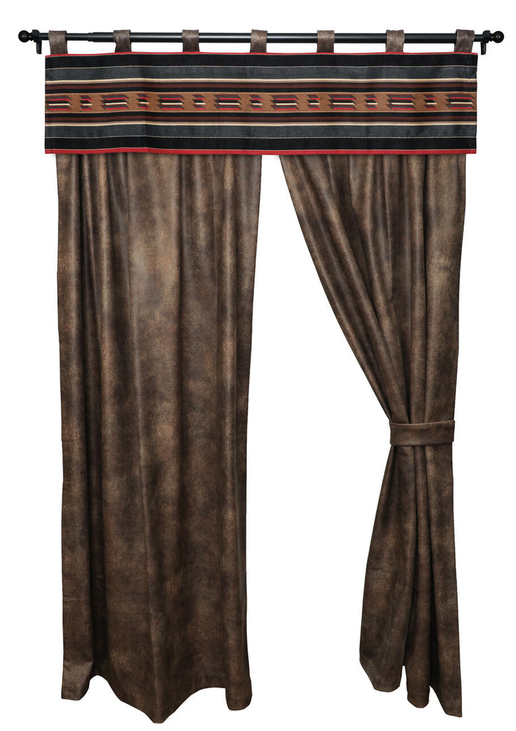 Wooded River Sun Valley Mojave Drape Set displayed in a rustic bedroom setting. Made from distressed brown faux leather (100% Polyester), the panels feature a 3-inch rod pocket and 1.5-inch header for easy hanging. Includes two drape panels and two tiebacks, complementing southwestern and cabin-inspired decor.