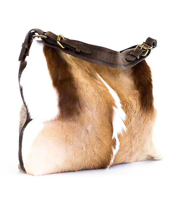 A brown and white antelope shoulder bag with a leather strap and zippered pocket.